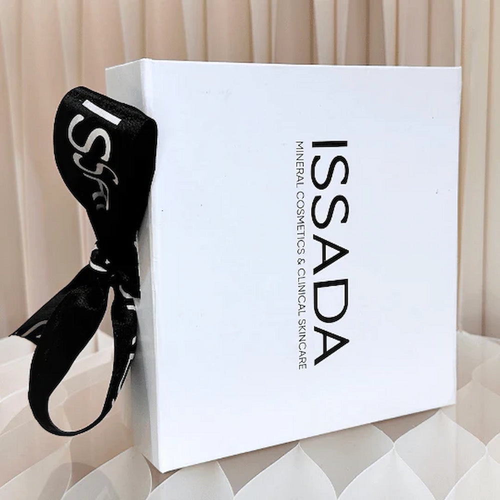 Stylish Issada white gift box tied with a black branded ribbon, designed for presenting luxury cosmetics and skincare.