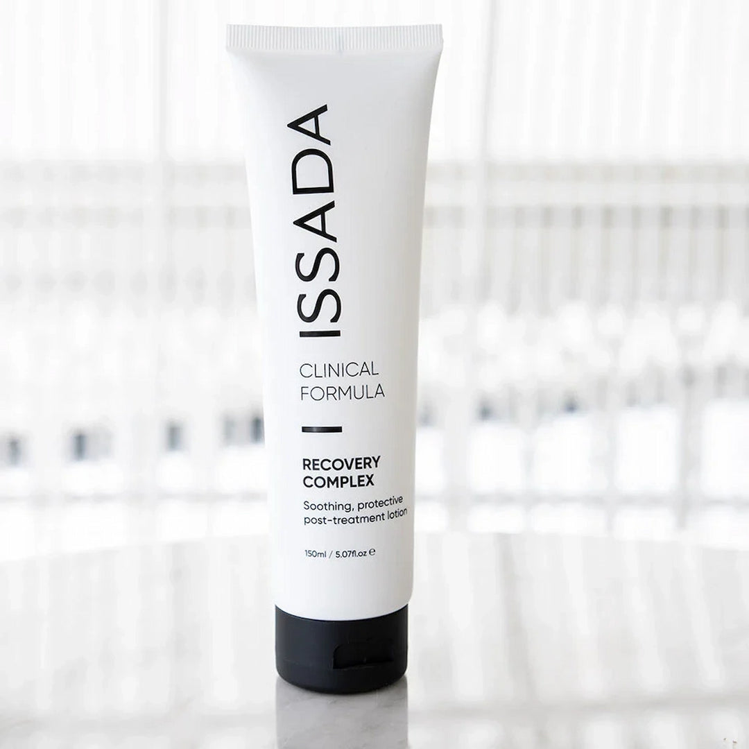 White tube of Issada Recovery Complex, a hydrating and soothing lotion designed to protect and calm skin after treatments.