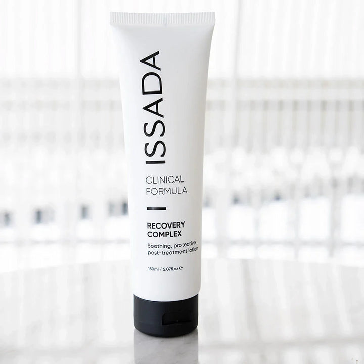 White tube of Issada Recovery Complex, a hydrating and soothing lotion designed to protect and calm skin after treatments.